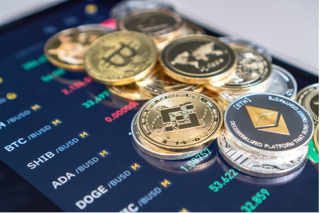 image of different cryptocurrency coins and prices on background