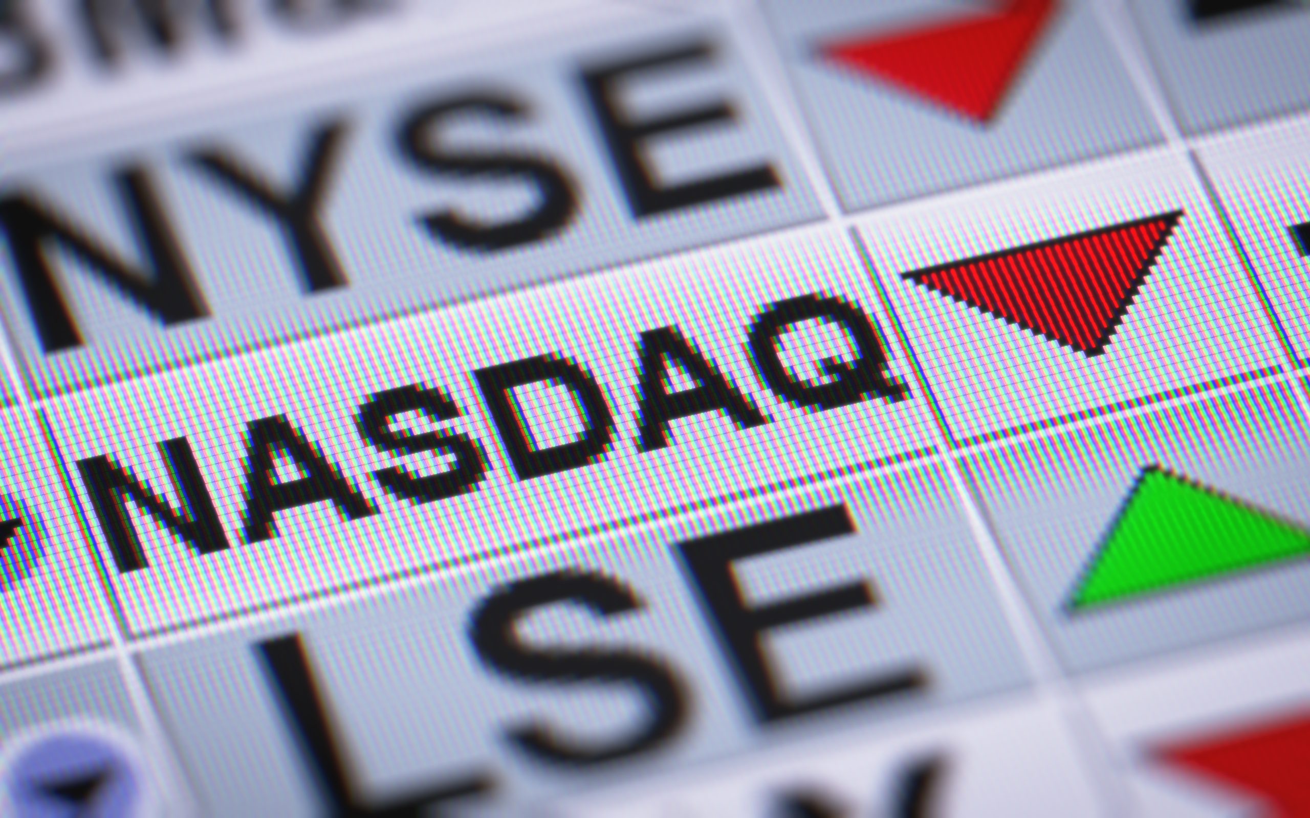 Close-up of a calendar view with a red warning triangle and a green marker indicating an upcoming deadline or alert on a date.
